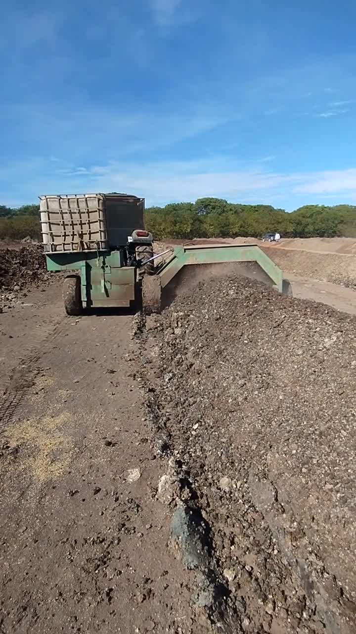 Turning the compost windrows.